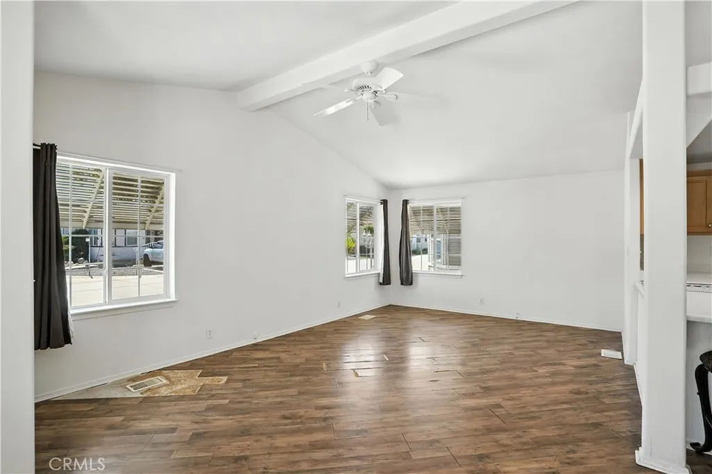 27250 Murrieta Road, Unit 216 Menifee, CA 92586 - Photo 7 of 58 a view of an empty room with wooden floor and a window