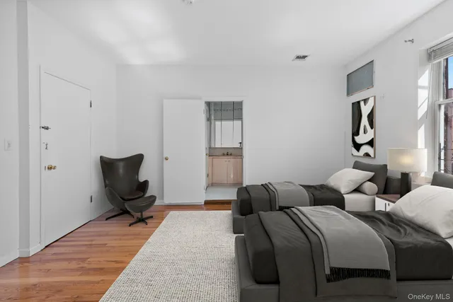 a hotel room with two beds and a chair