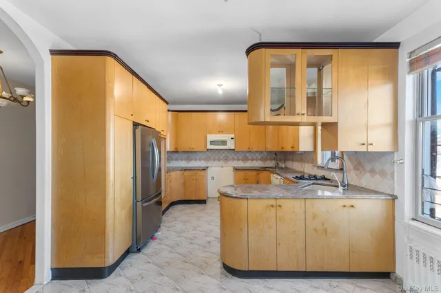a view of a kitchen with a sink and dishwasher with wooden floor