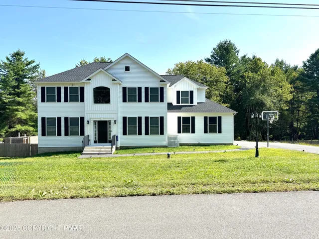 a view of a house with a yard porch and sitting area
