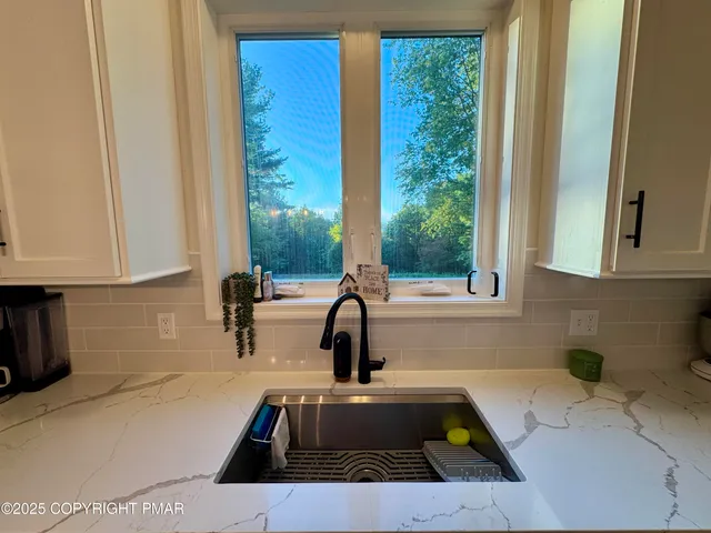 a kitchen with a sink a counter top space and cabinets