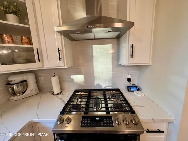 a kitchen with a stove and cabinets