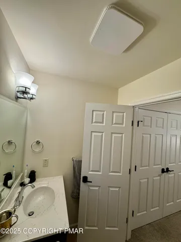 a spacious bedroom with a bed and a flat screen tv