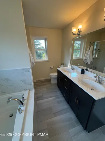 a bathroom with a bathtub and a shower
