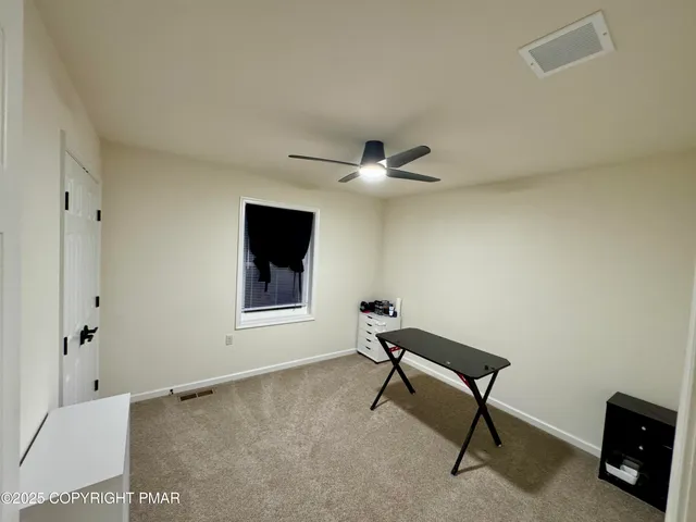 a view of a hallway with wooden floor and a potted plant