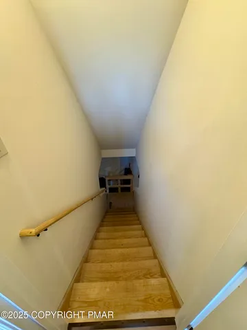 a view of water heater room with stairs