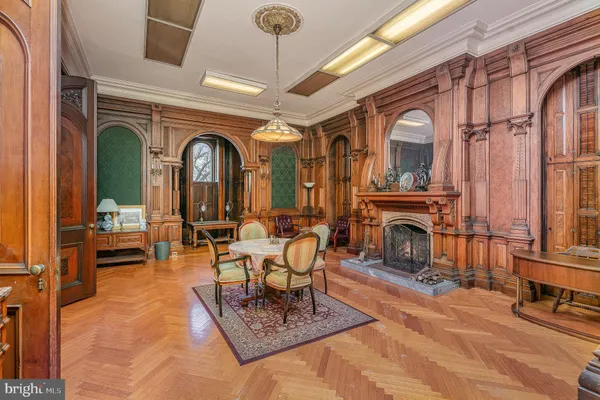 a living room with furniture a dining table and chairs with wooden floor
