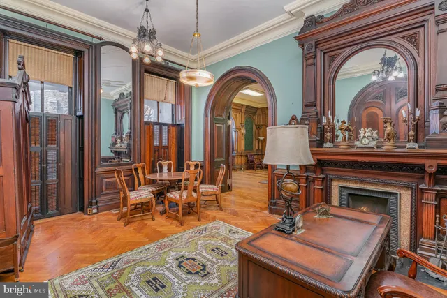 a room with chandelier fan and windows