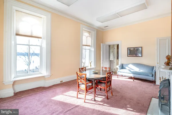 a view of a livingroom with furniture and staircase