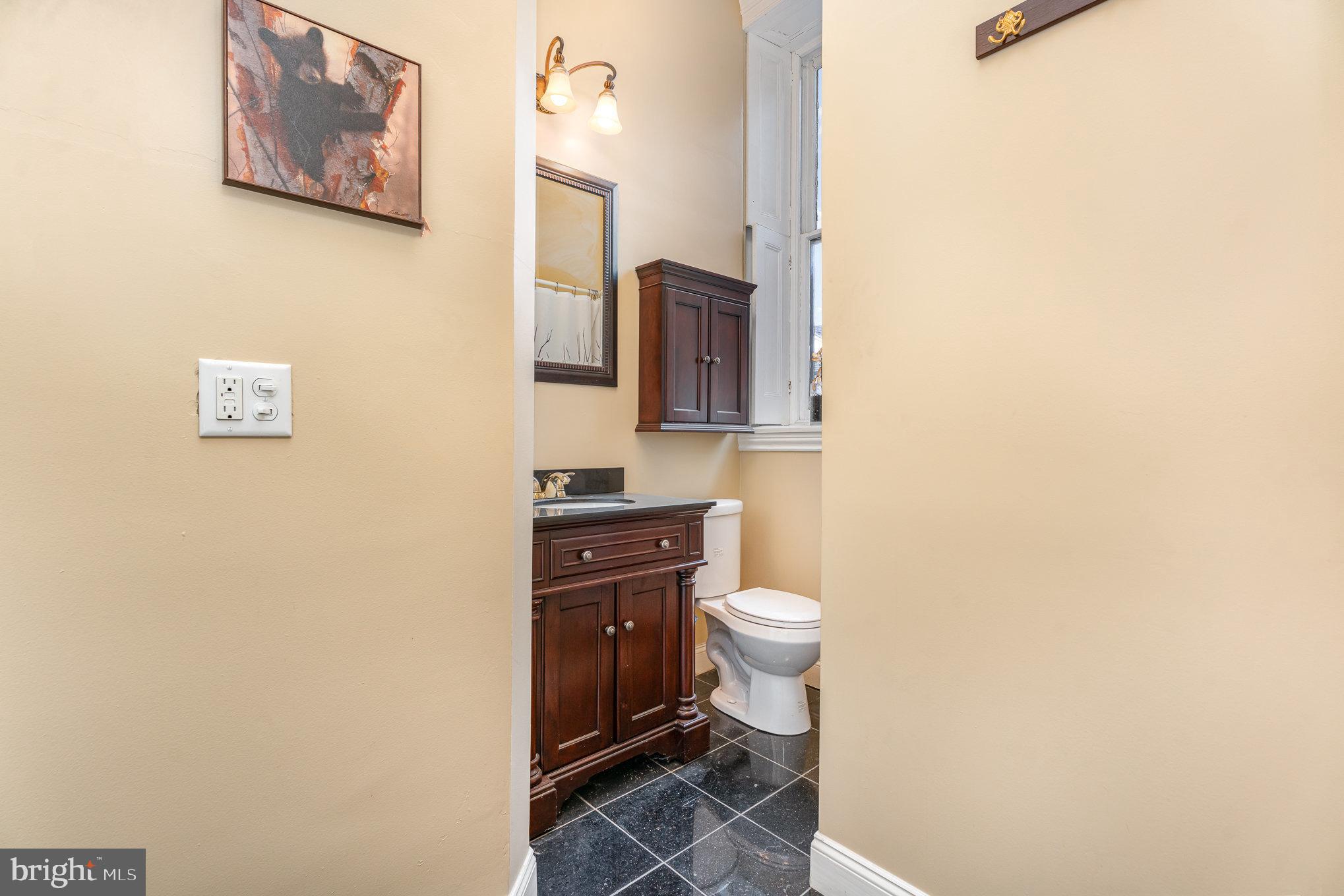 407 North Front Street Harrisburg, PA 17101 - Photo 33 of 52 a bathroom with a toilet a sink and mirror