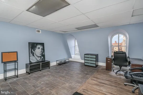 a view of a hallway to a livingroom with furniture