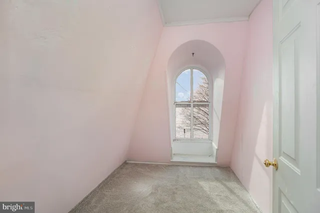 a view of a room that has a table and chair in it