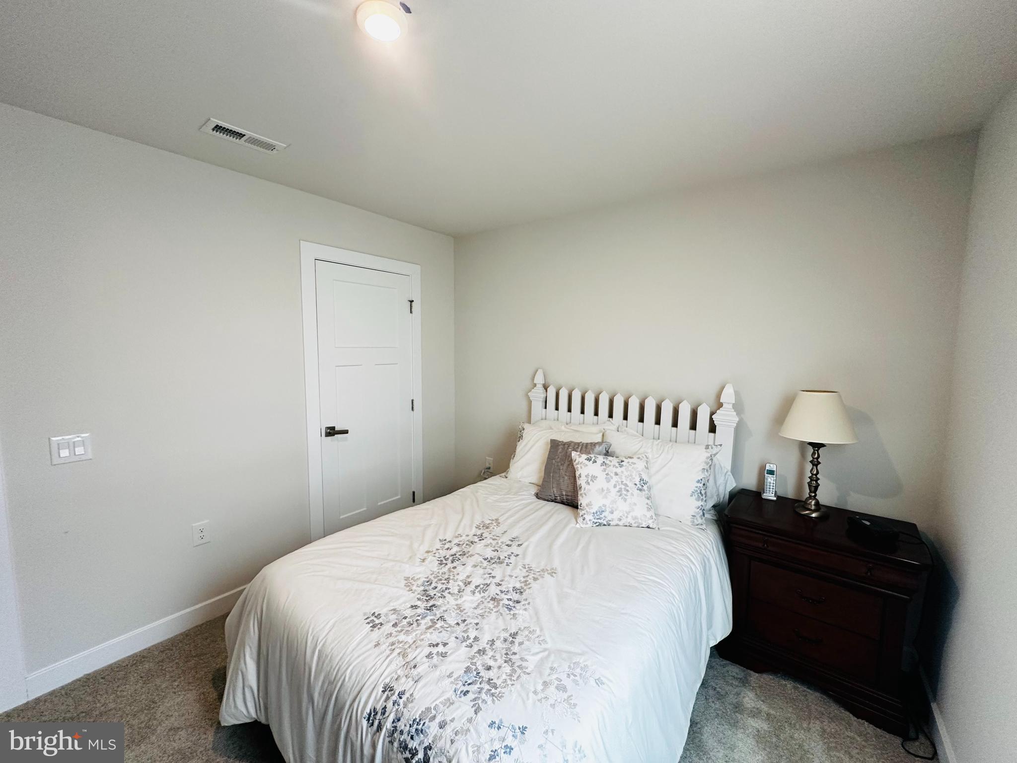 100 Senators Way Berlin, NJ 08009 - Photo 8 of 25 a bedroom with a bed and a lamp