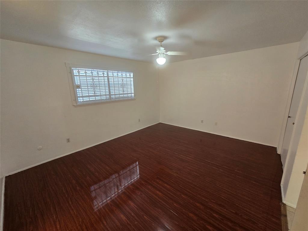 8071 Meadow Road, Unit 218 Dallas, TX 75231 - Photo 11 of 24 an empty room with wooden floor and windows