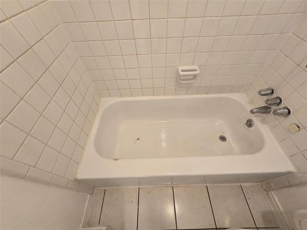 8071 Meadow Road, Unit 218 Dallas, TX 75231 - Photo 12 of 24 a bathroom with a bathtub