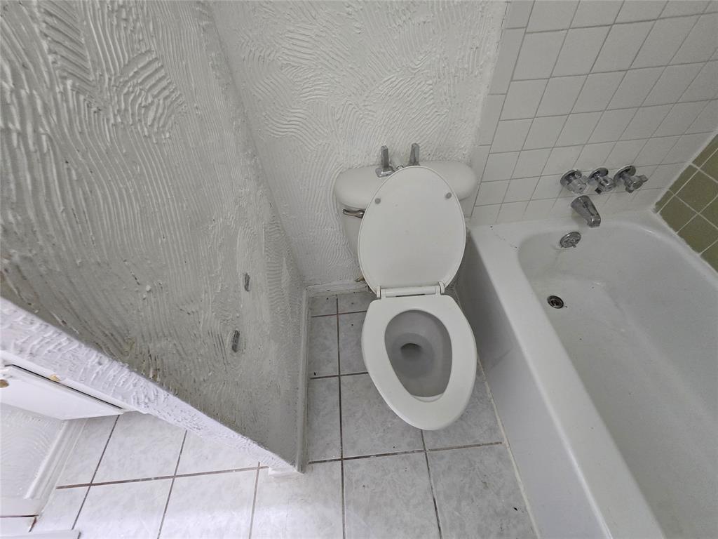 8071 Meadow Road, Unit 218 Dallas, TX 75231 - Photo 20 of 24 a bathroom with a toilet and a sink