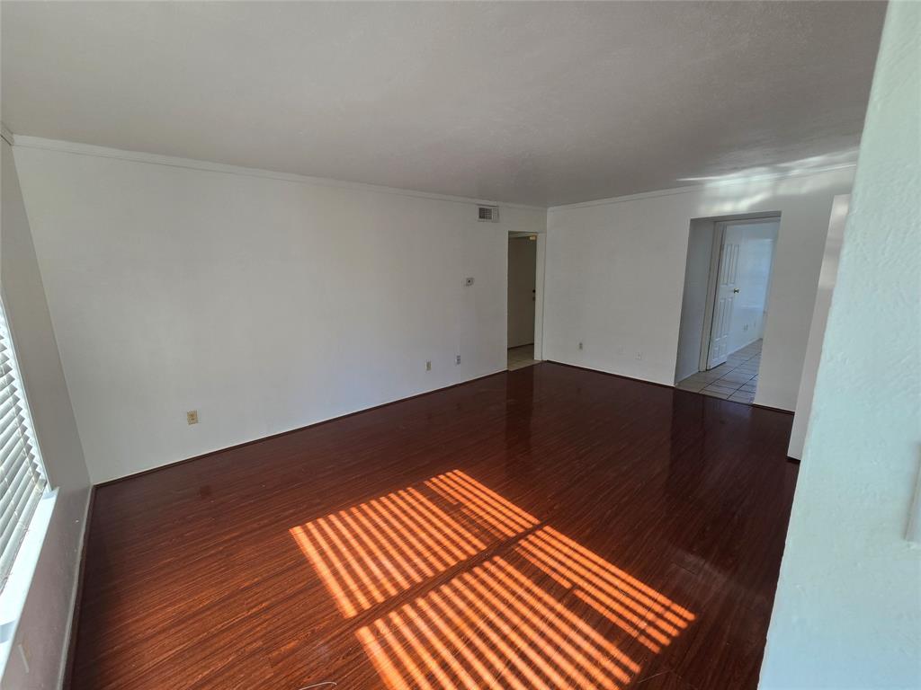 8071 Meadow Road, Unit 218 Dallas, TX 75231 - Photo 24 of 24 an empty room with wooden floor
