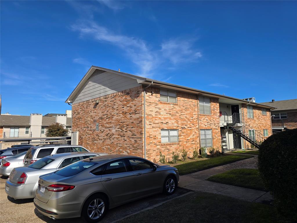 8071 Meadow Road, Unit 218 Dallas, TX 75231 - Photo 4 of 24 a view of a car parked in front of a house