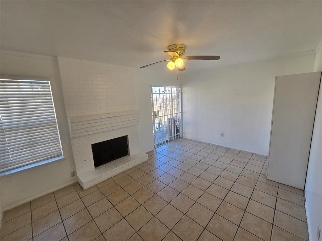 8071 Meadow Road, Unit 218 Dallas, TX 75231 - Photo 7 of 24 an empty room with windows and fireplace