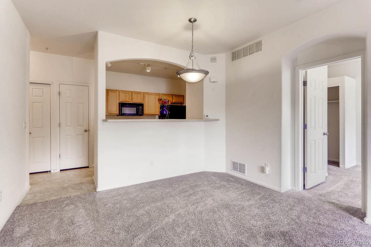 5255 Memphis Street, Unit 811 Denver, CO 80239 - Photo 4 of 12 a view of a kitchen with a sink and a cabinet mirror