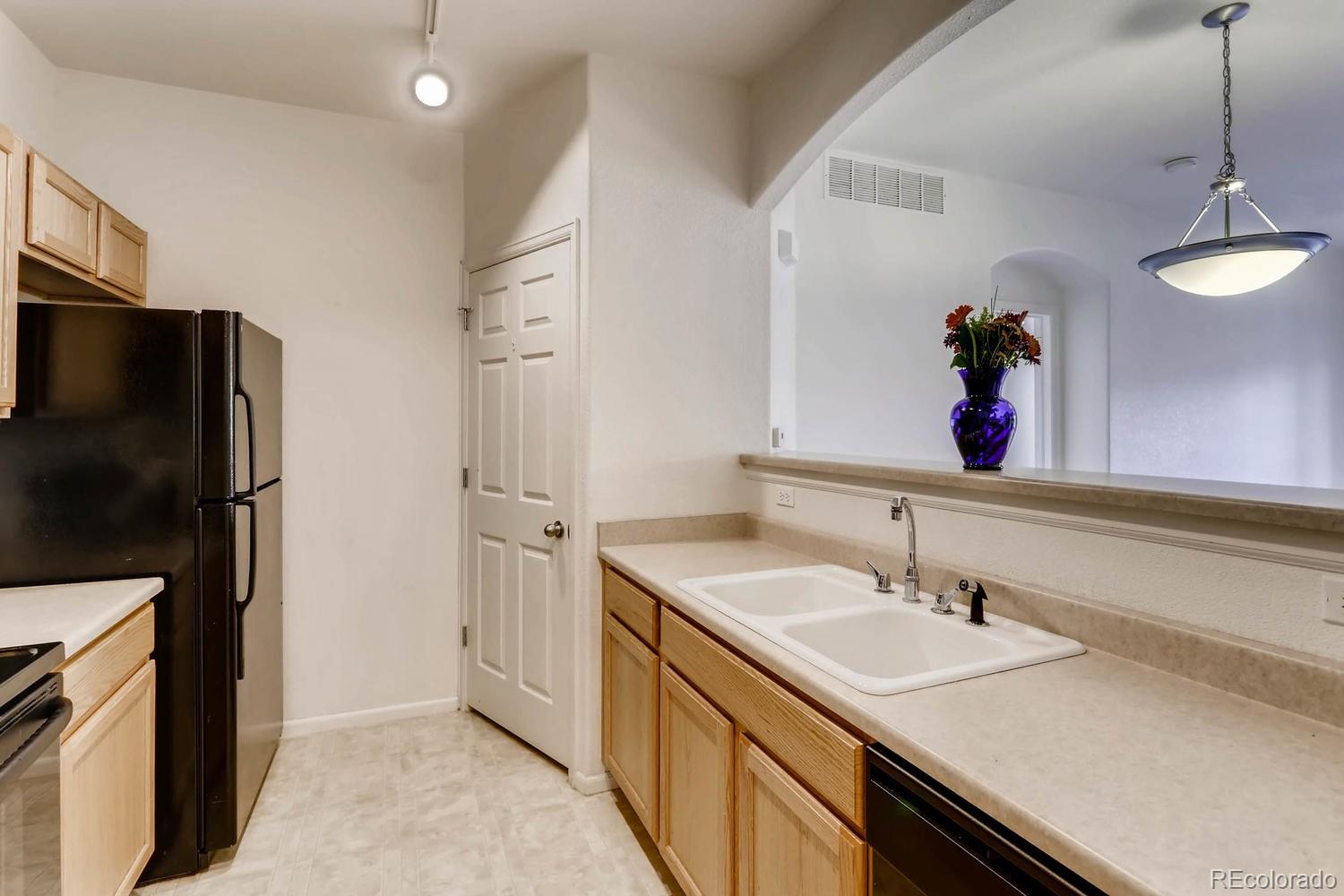 5255 Memphis Street, Unit 811 Denver, CO 80239 - Photo 6 of 12 a bathroom with a sink double vanity and a mirror