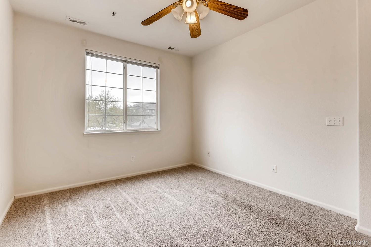 5255 Memphis Street, Unit 811 Denver, CO 80239 - Photo 9 of 12 an empty room with a window