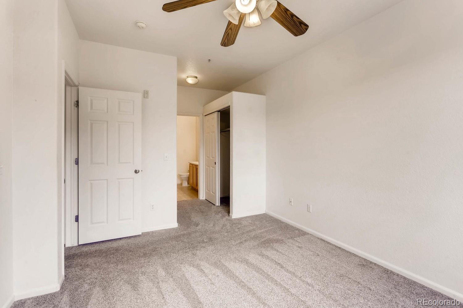 5255 Memphis Street, Unit 811 Denver, CO 80239 - Photo 10 of 12 an empty room with ceiling fan and window