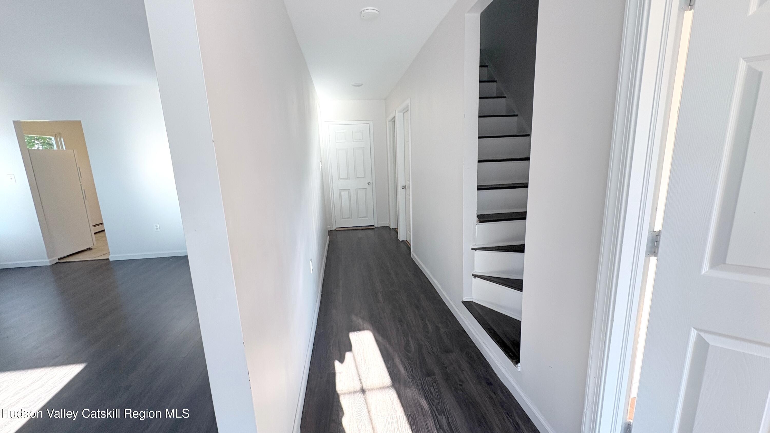 34 North Street, Unit 2 Catskill, NY 12414 - Photo 3 of 19 a view of a hallway with stairs and wooden floor
