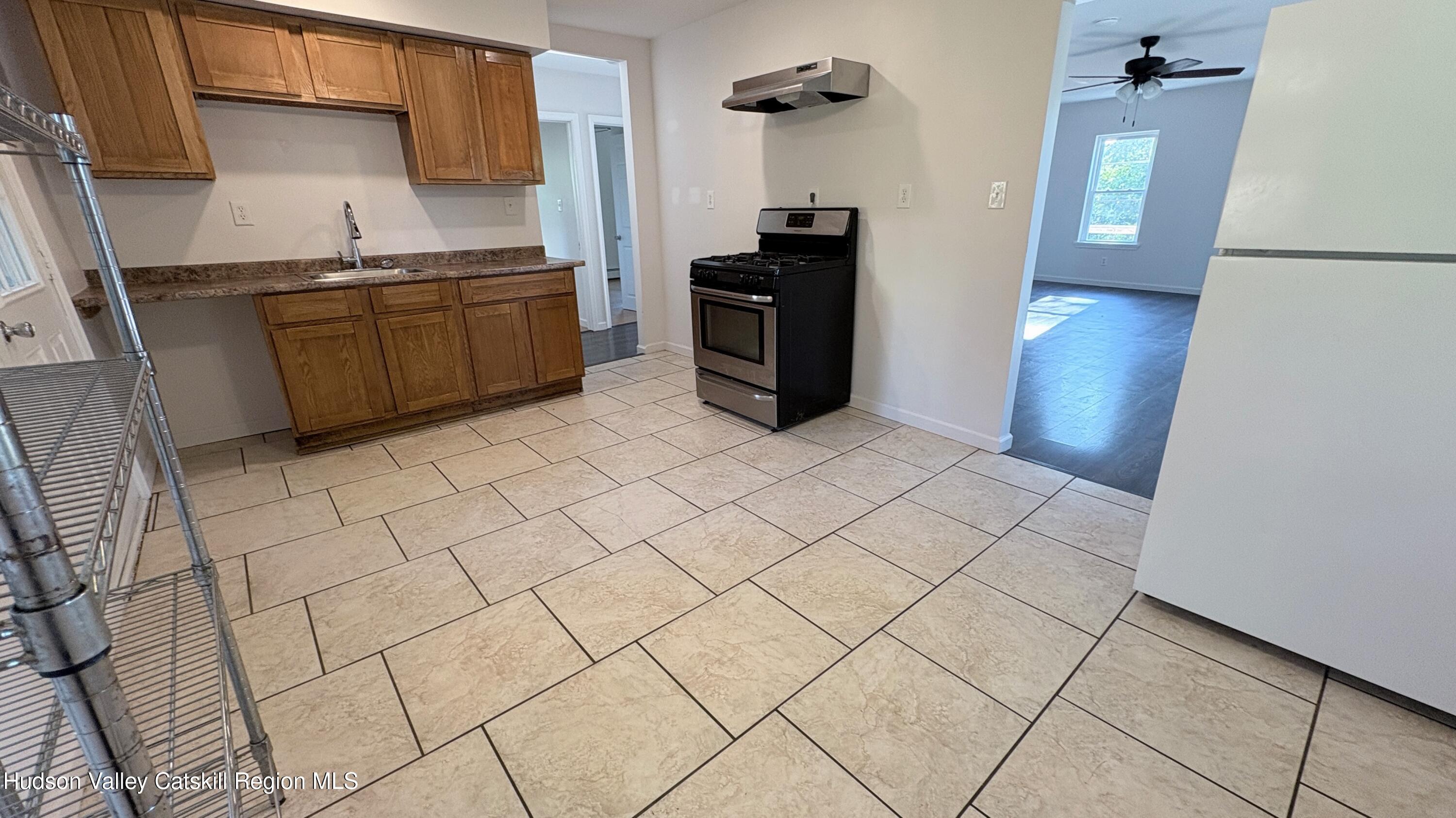 34 North Street, Unit 2 Catskill, NY 12414 - Photo 5 of 19 a kitchen with stainless steel appliances granite countertop a refrigerator and a stove top oven