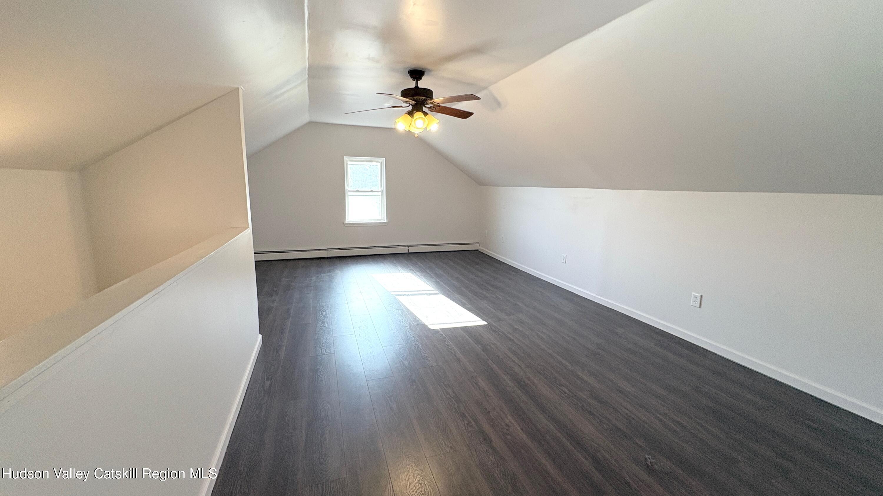 34 North Street, Unit 2 Catskill, NY 12414 - Photo 10 of 19 a view of a hallway with wooden floor and a chandelier