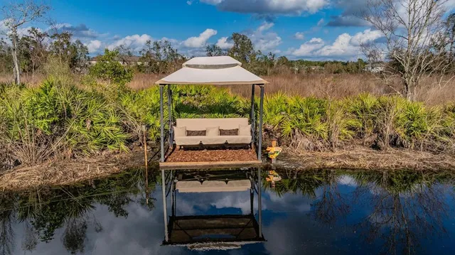 a wooden bench sitting in the middle of a lake