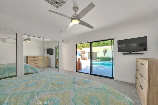 a room with a bed and a flat screen tv