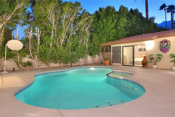 a view of a backyard with swimming pool