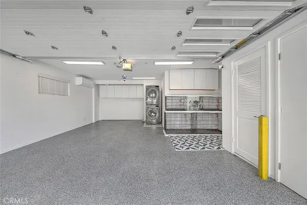 a view of empty room with refrigerator and cabinet