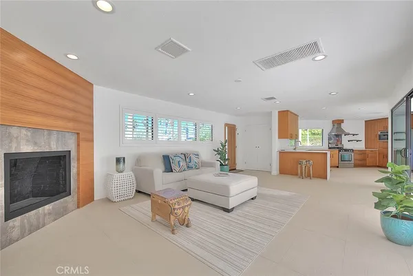 a living room with a large window and walk in closet with balcony view