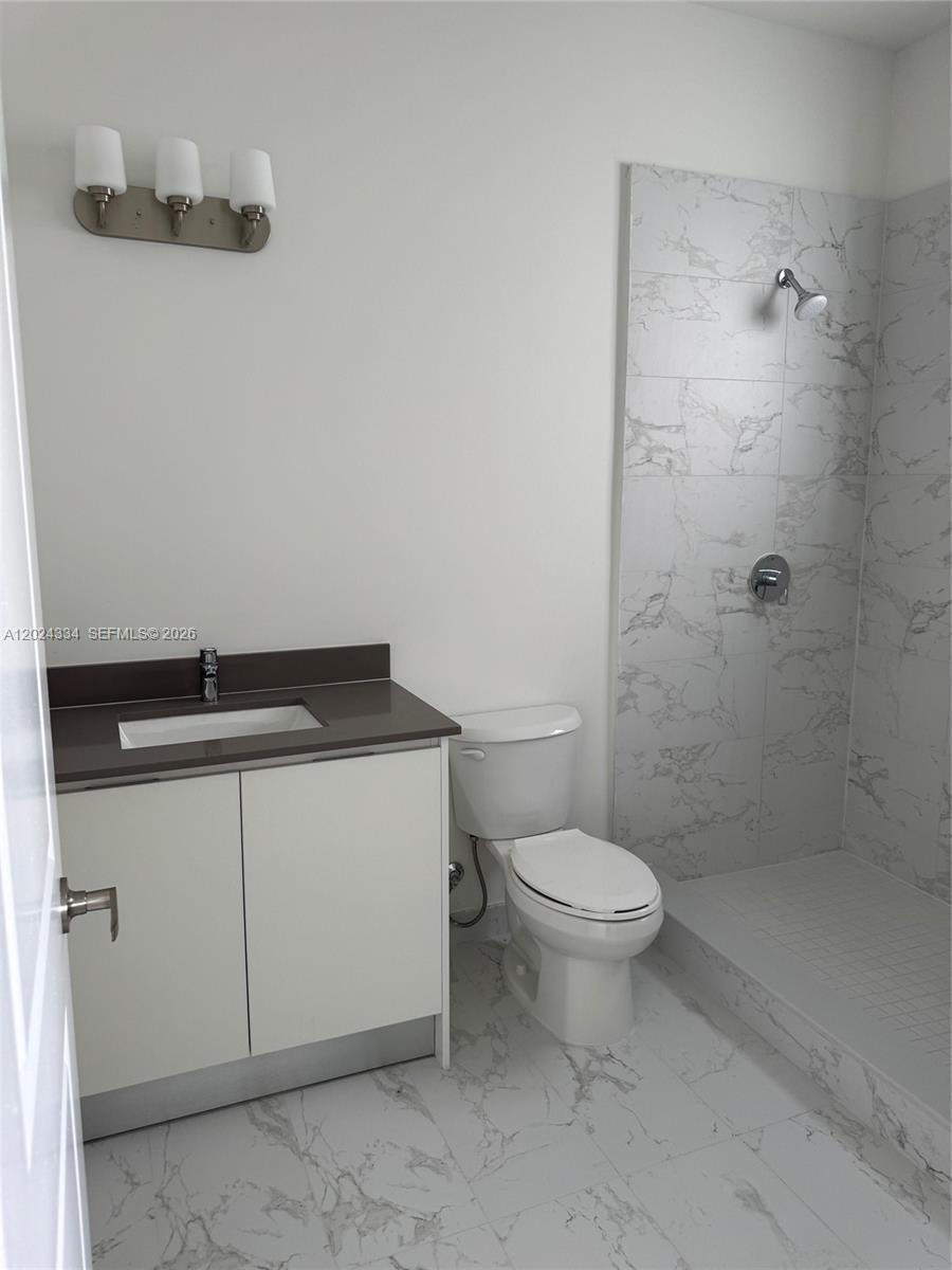 19115 Southwest 344th Terrace Homestead, FL 33034 - Photo 3 of 7 a bathroom with a sink a toilet and shower