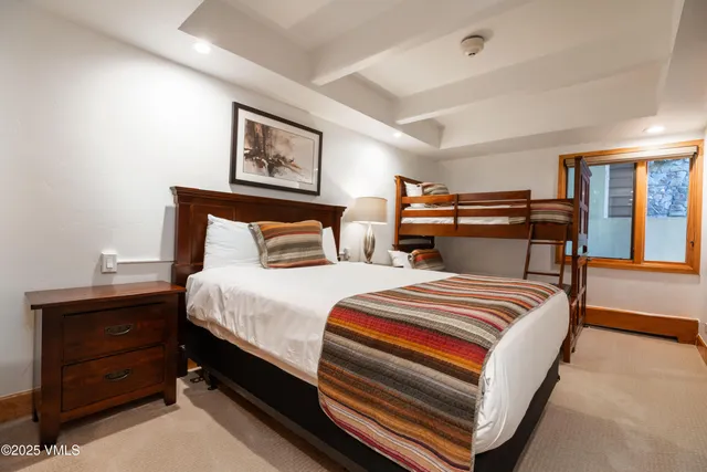 a bedroom with beds and a window