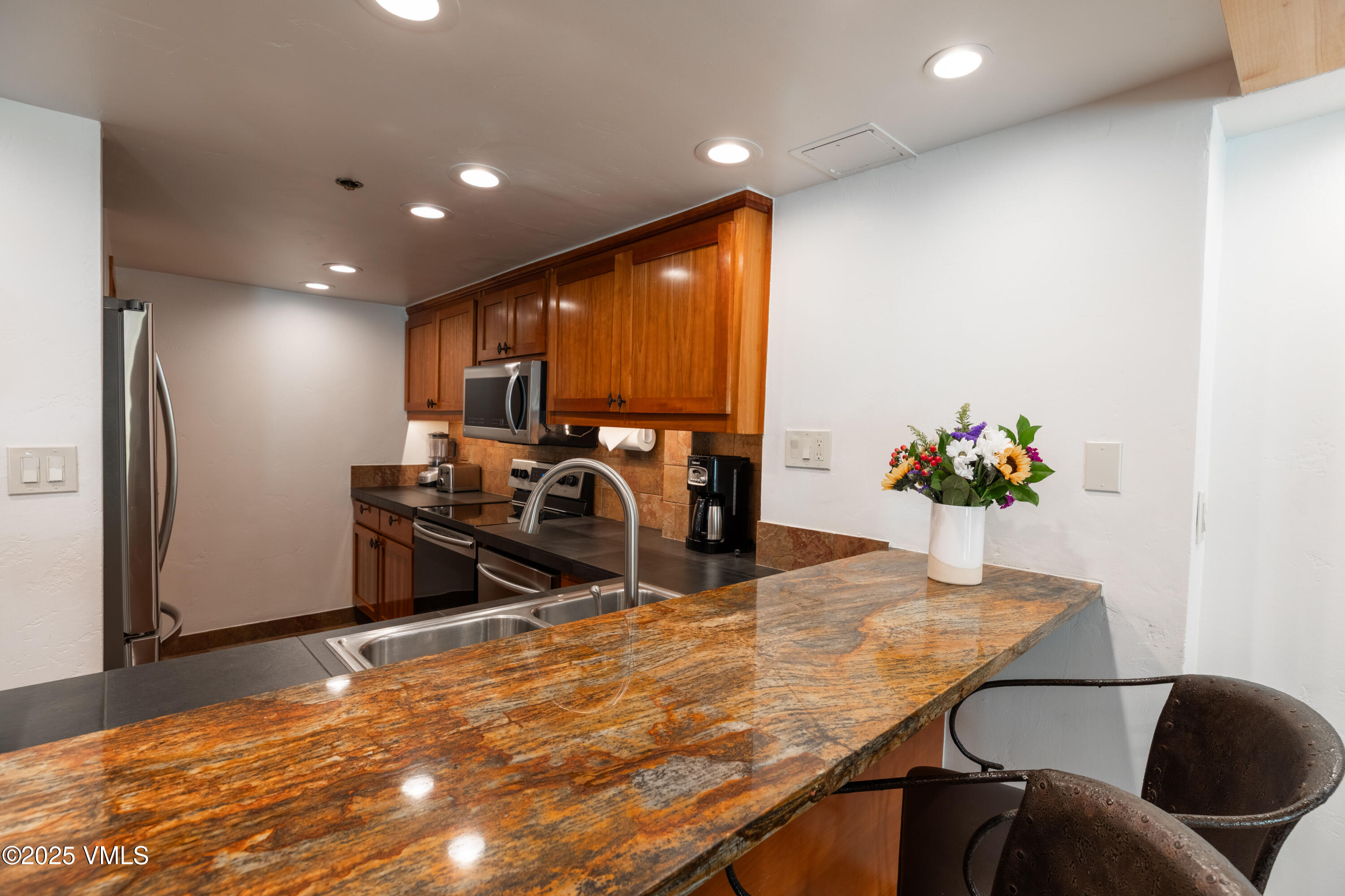 390 East Lionshead Circle, Unit 103 Vail, CO 81657 - Photo 6 of 22 a view of a dining room with furniture