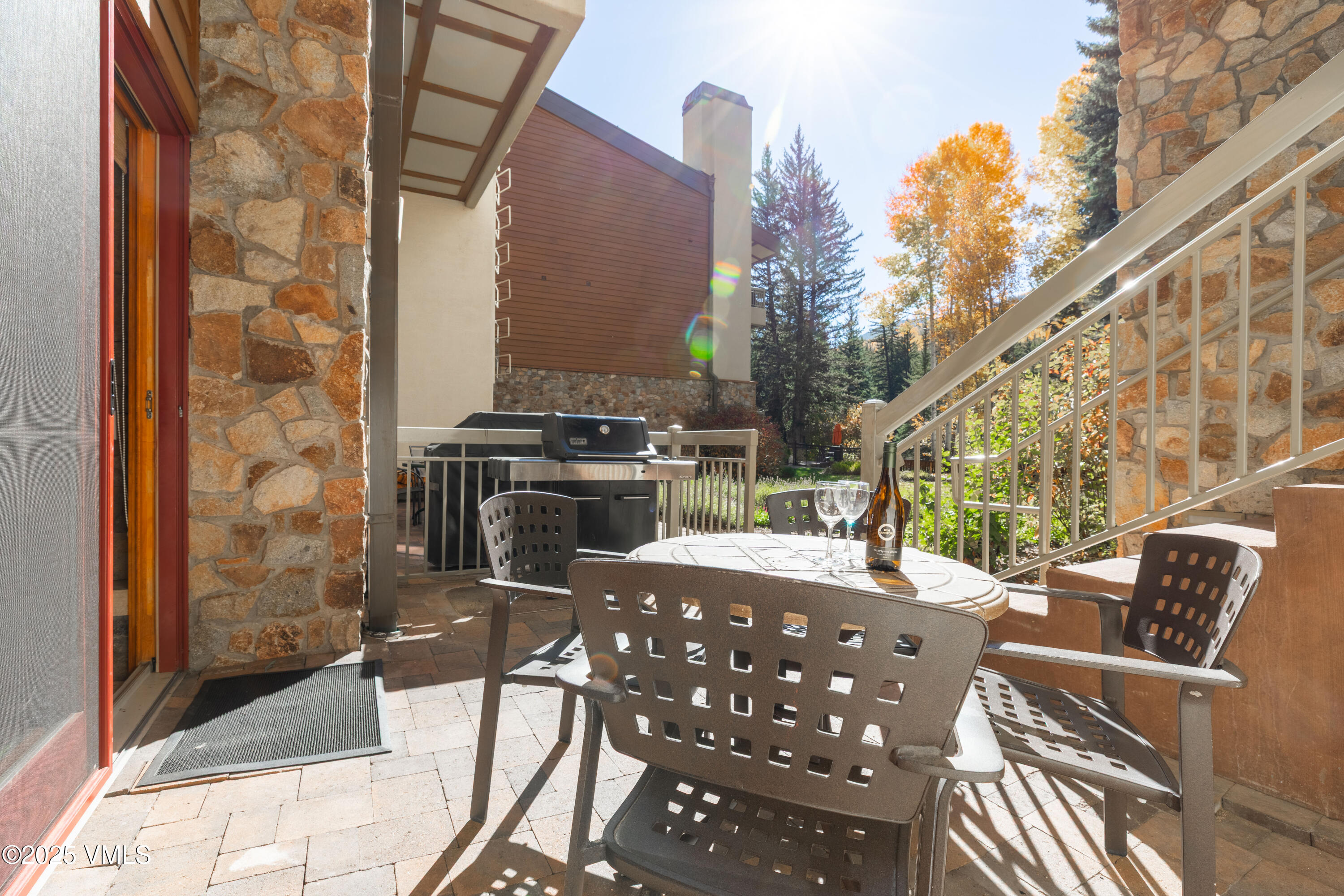 390 East Lionshead Circle, Unit 103 Vail, CO 81657 - Photo 8 of 22 a view of a chairs and table in the balcony
