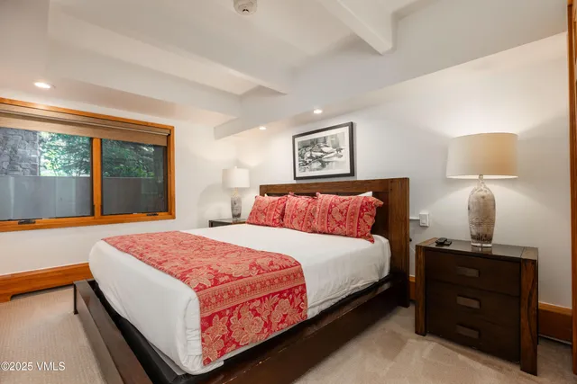 a bedroom with bed and large window