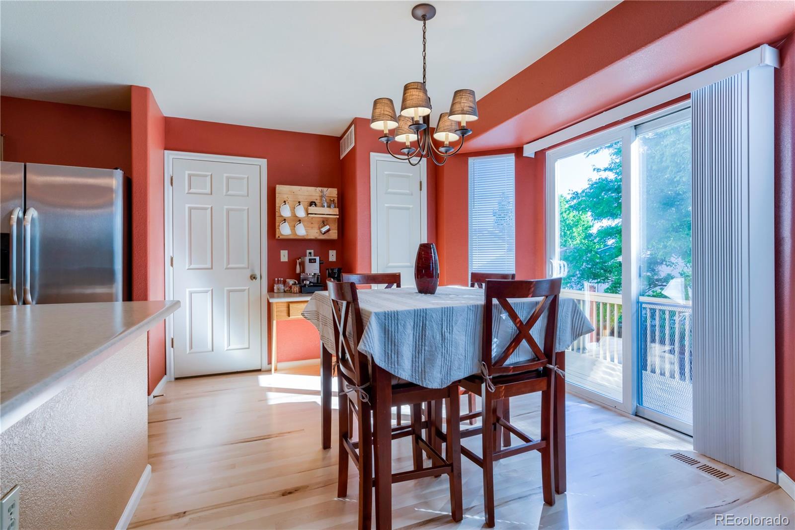 1290 Trail Ridge Road Longmont, CO 80504 - Photo 12 of 38 a view of a dining room with furniture window and wooden floor