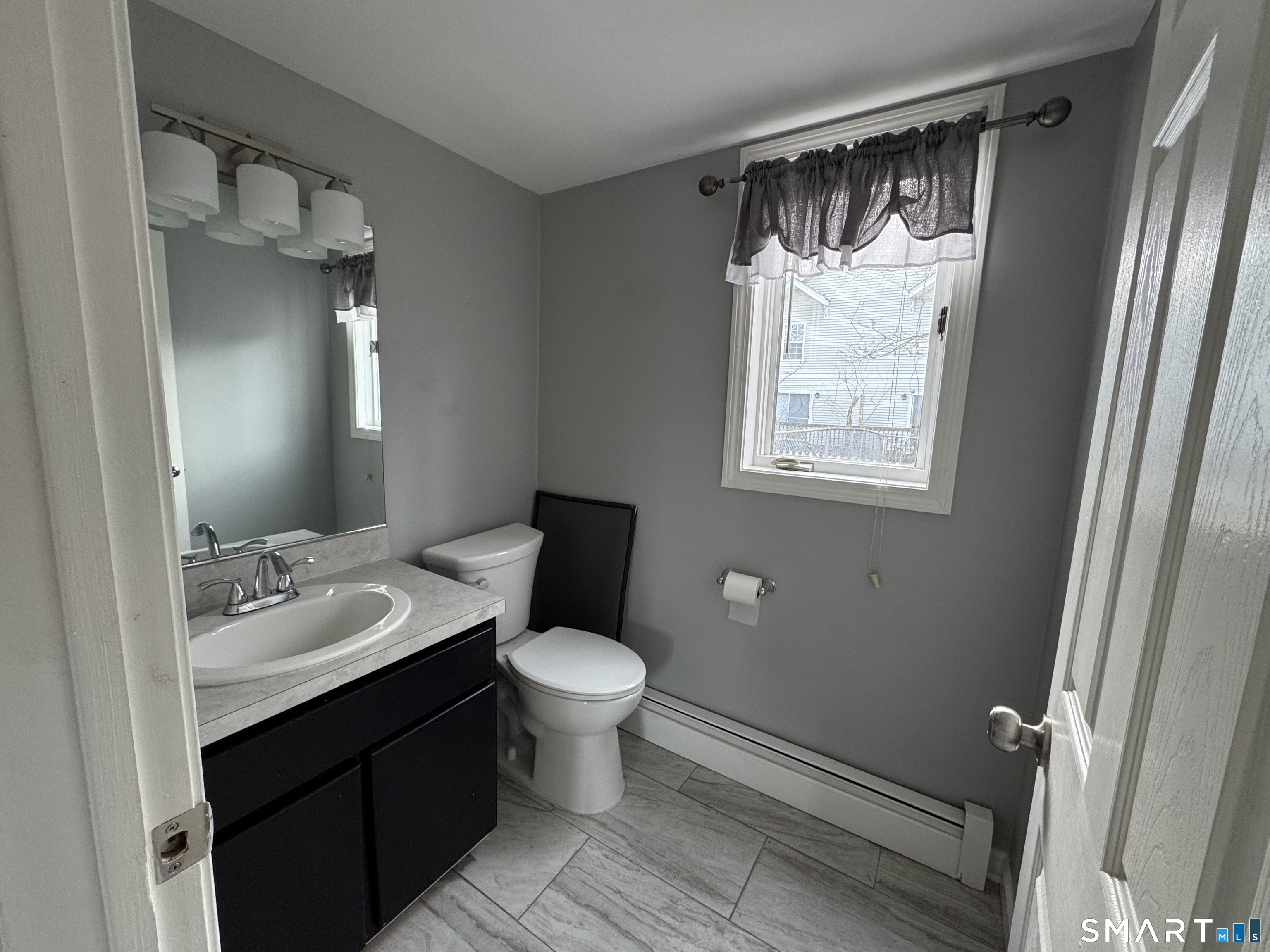 27 Katie Lane Waterbury, CT 06708 - Photo 5 of 14 a bathroom with a sink toilet a mirror and shower