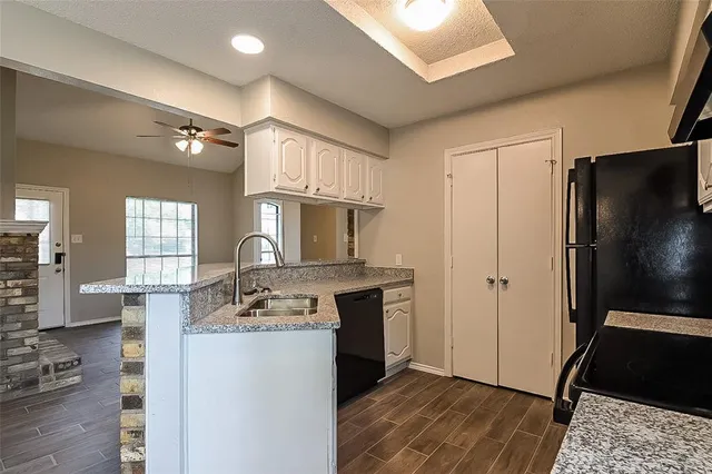 a spacious bathroom with a granite countertop sink a mirror and shower