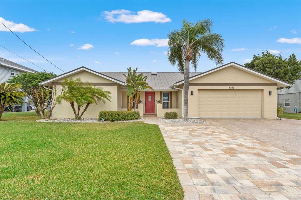 4383 Biscayne Drive Hernando Beach, FL 34607 - Photo 1 of 1 a front view of a house with garden