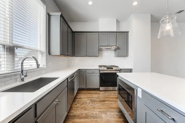 a kitchen with a sink stove and cabinets
