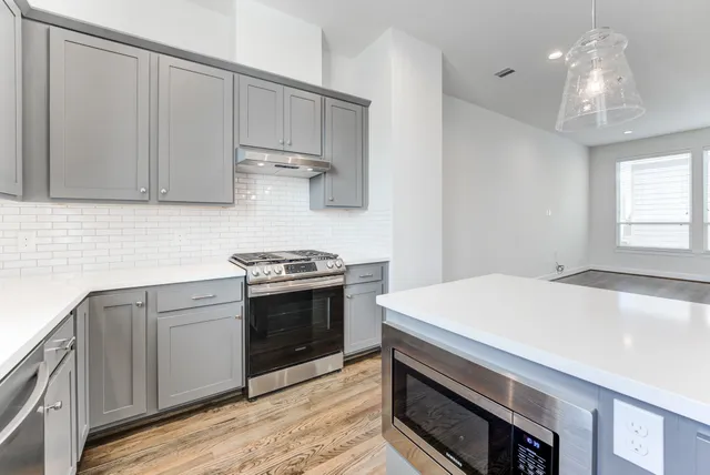 a kitchen with kitchen island a sink stainless steel appliances and cabinets