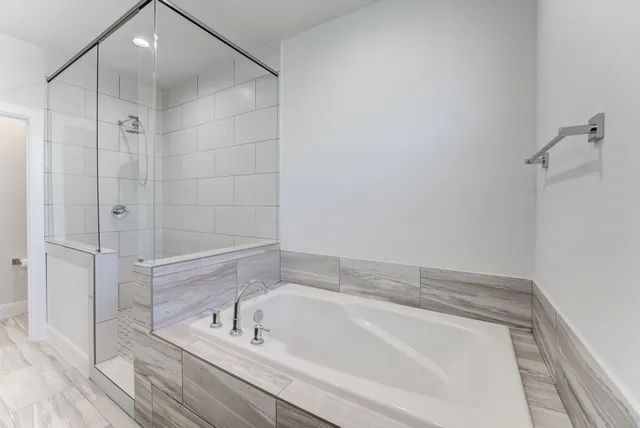 a bathroom with a bathtub and a shower
