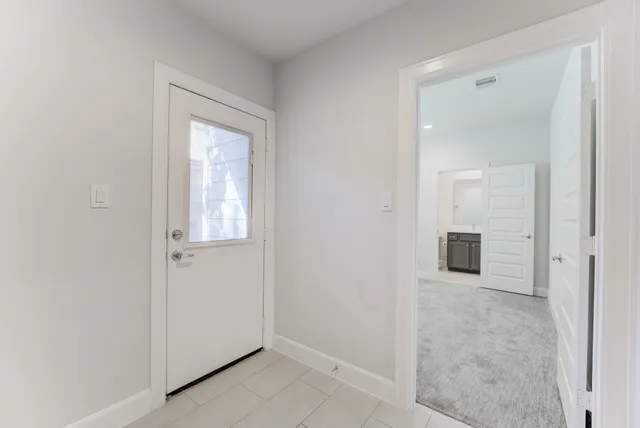 an empty room with windows and closet