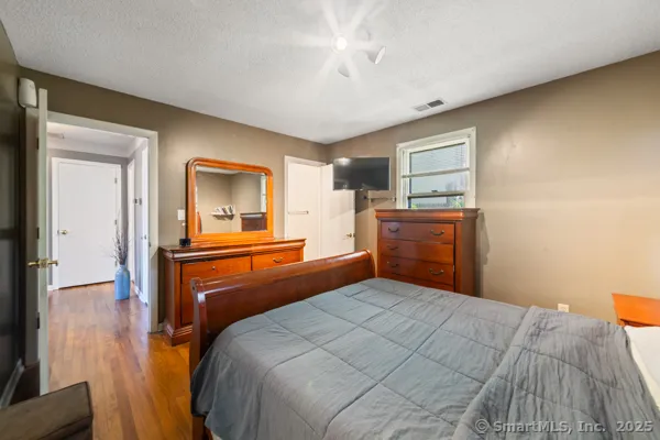 a bedroom with a bed and a desk