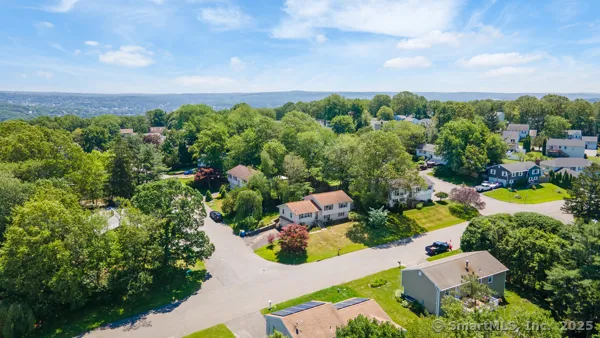 an aerial view of multiple houses with yard